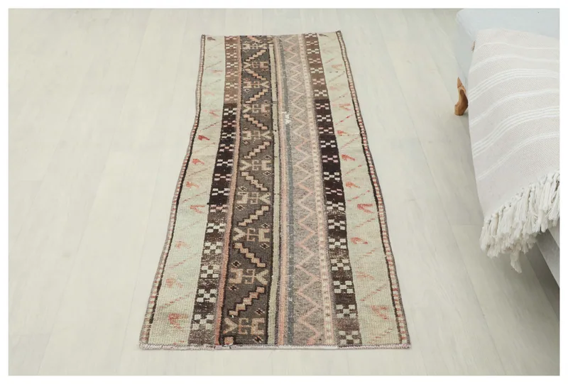 Full overhead view of the beige and brown tribal striped runner rug