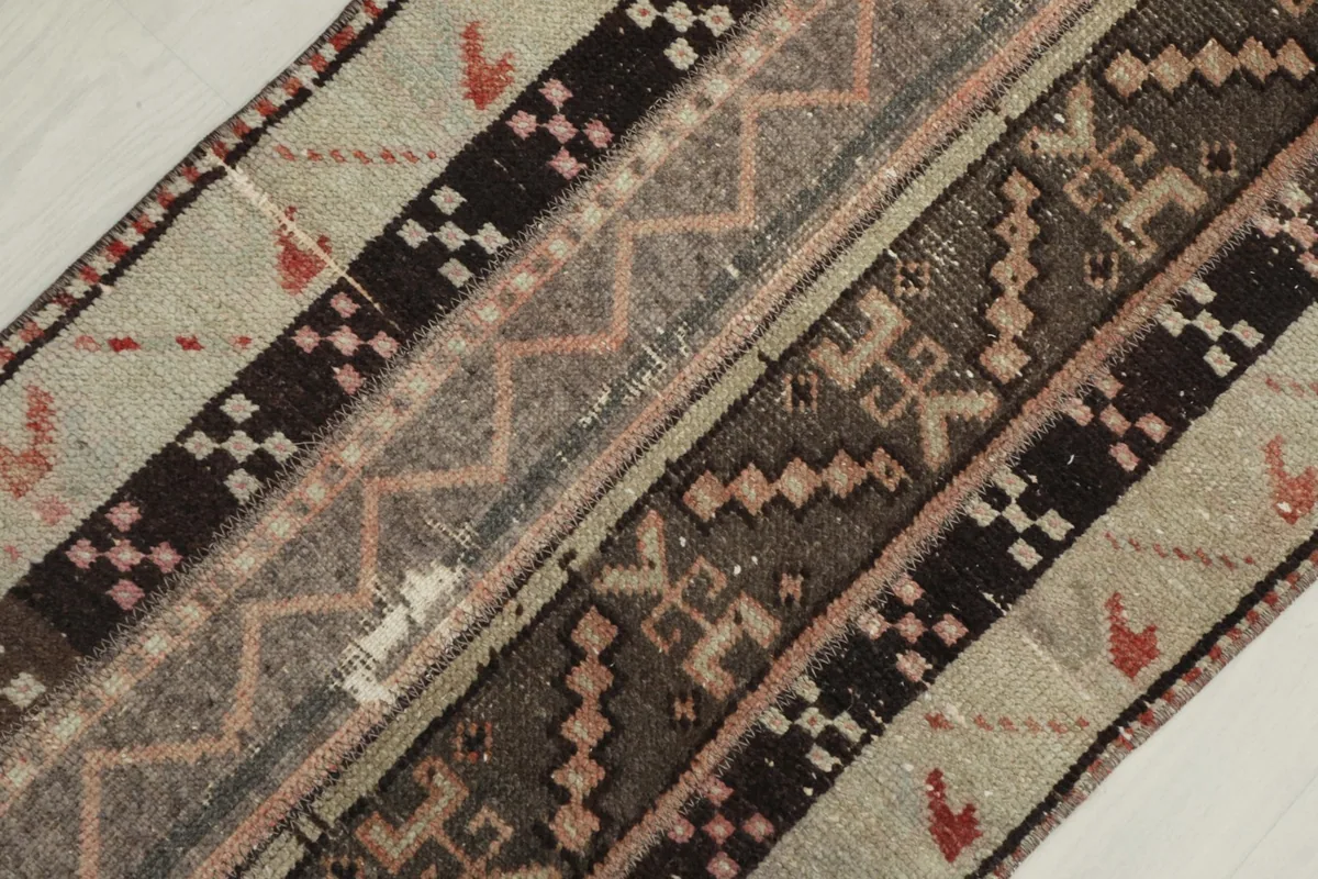 Diagonal close-up view of the rug's central design elements, including zigzag and step patterns