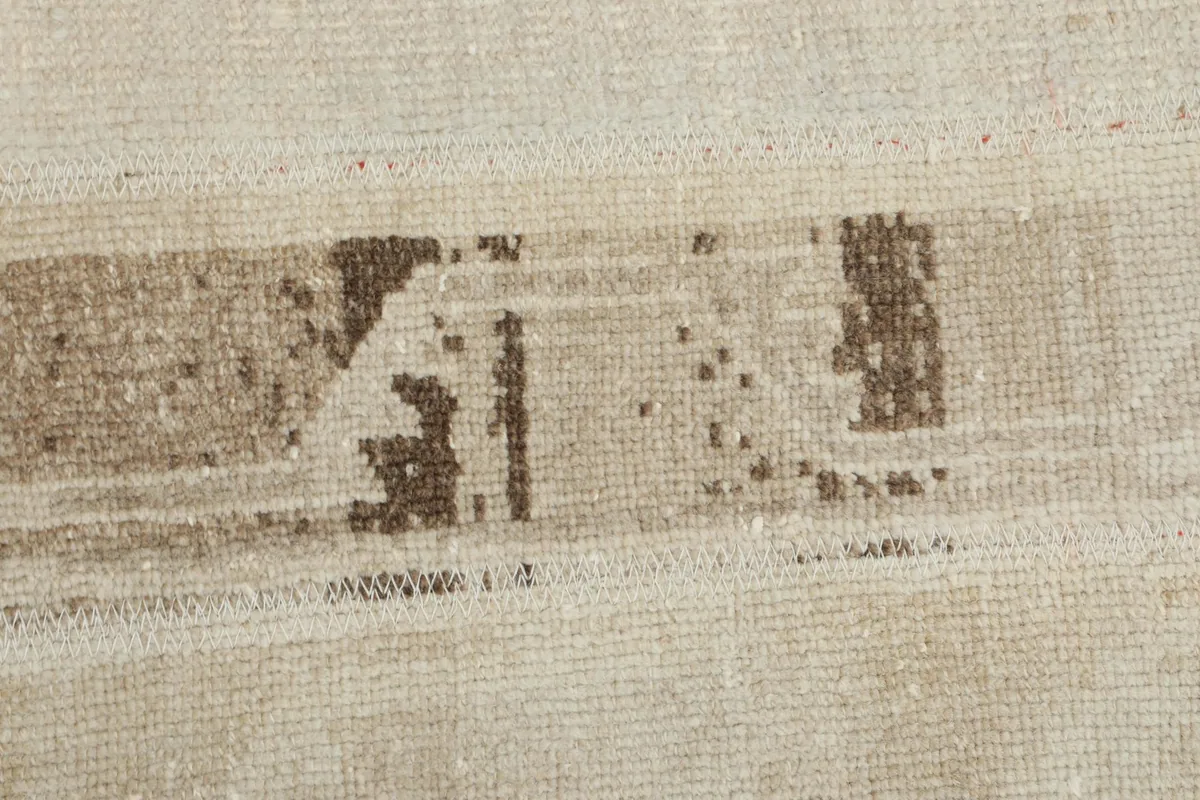 Close-up of the intricate distressed patterns and color variations in the rug's pile