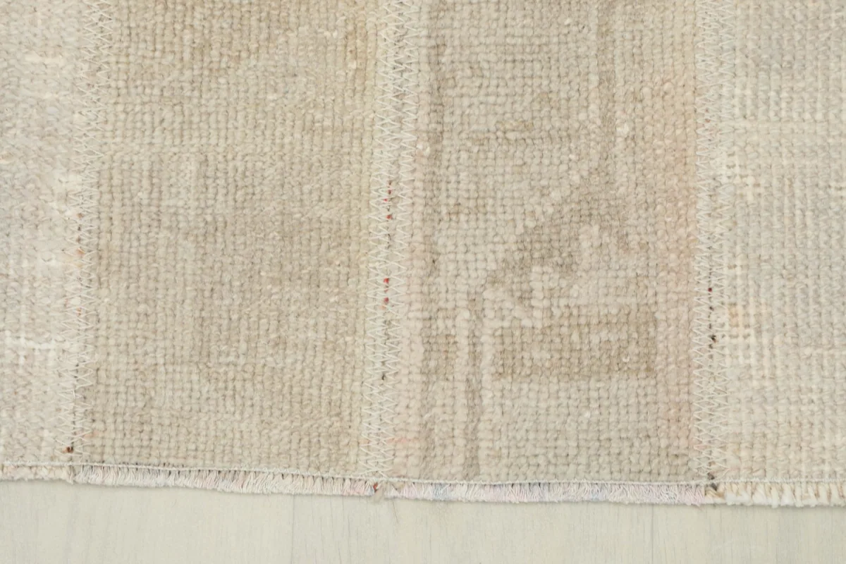Extreme close-up showing the low wool pile texture and hand-knotted weave of the runner