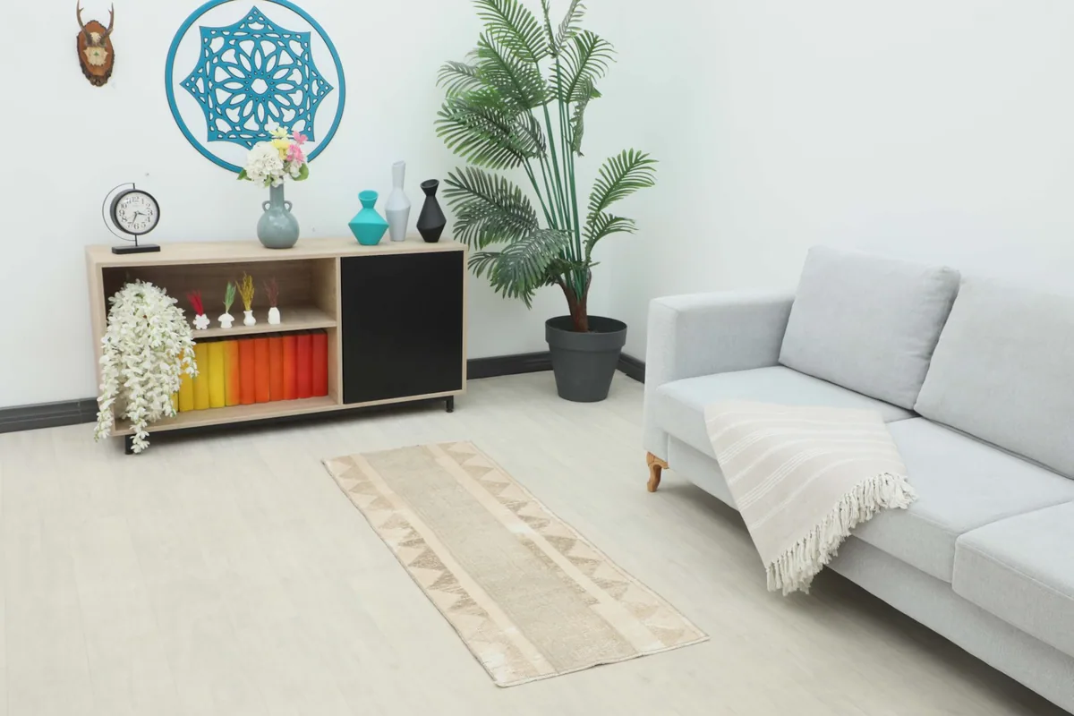 Vintage beige and tan runner rug styled in a modern living room setting, complementing light furniture.