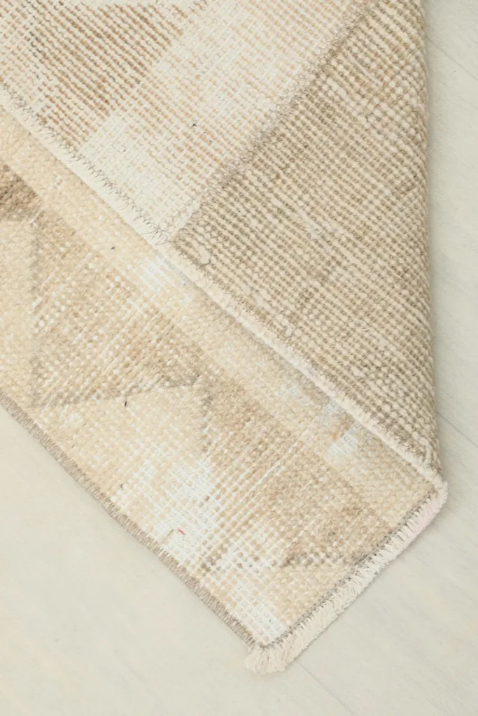 View of the back of the hand-knotted runner rug, illustrating the cotton foundation and craftsmanship.