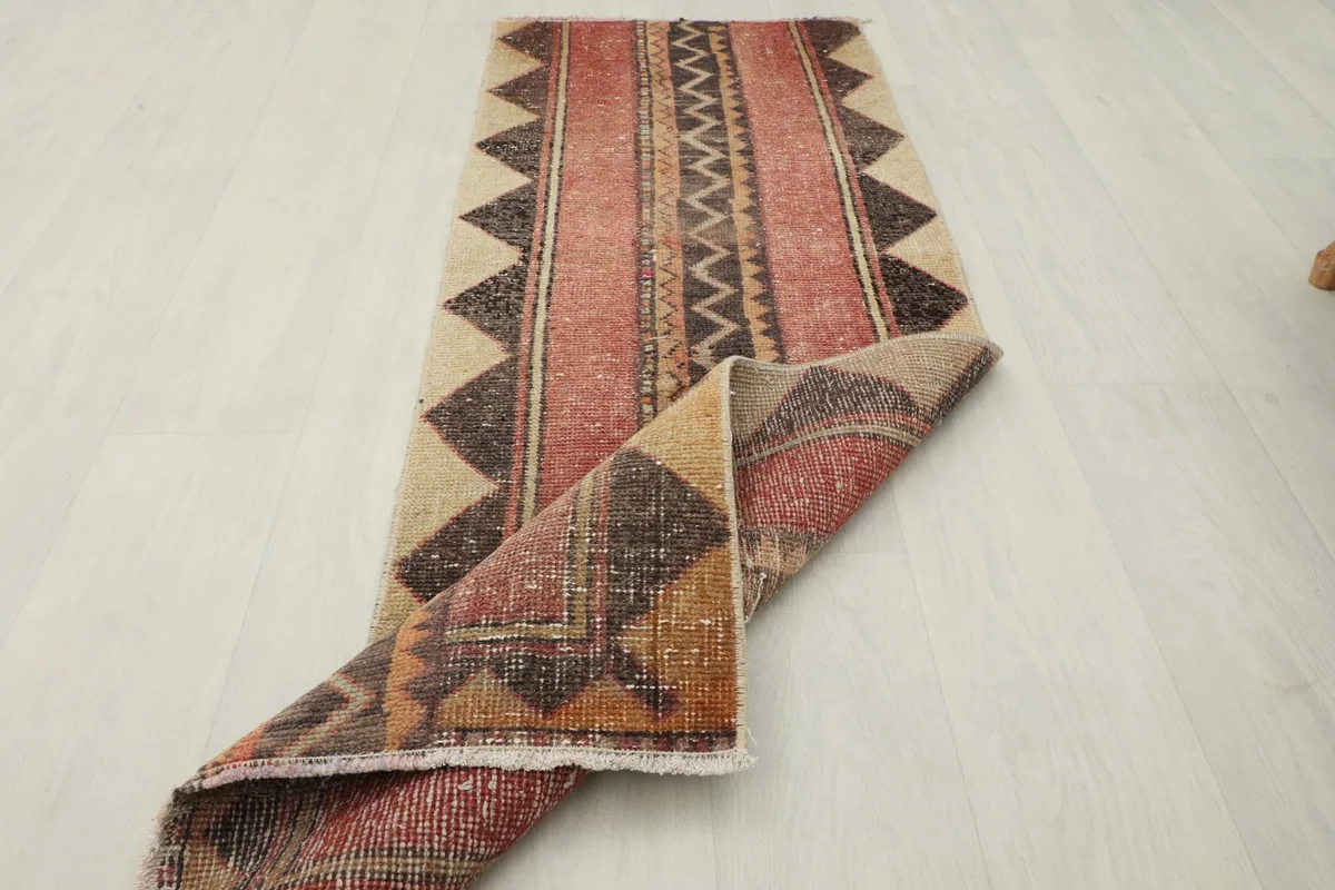The runner rug partially folded, showing its flexibility and the full pattern.