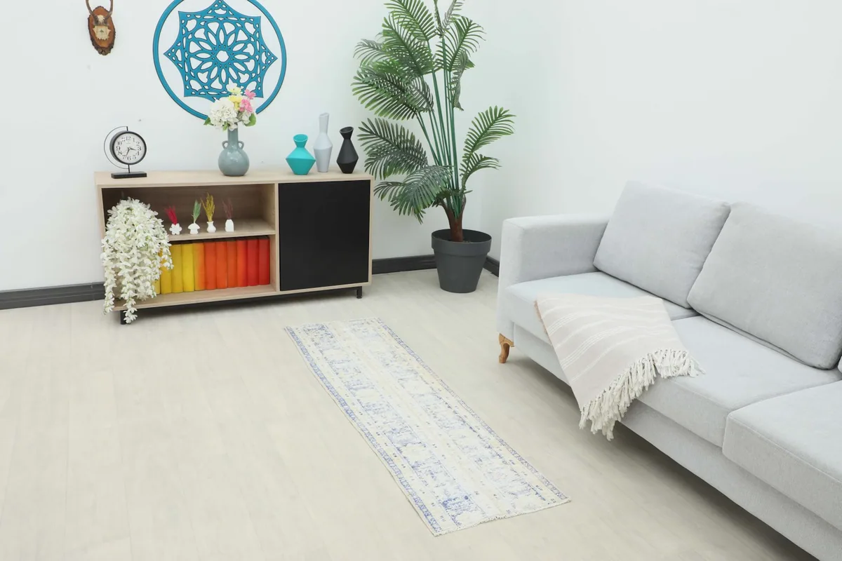 Blue and ivory runner rug placed in a modern living room setting