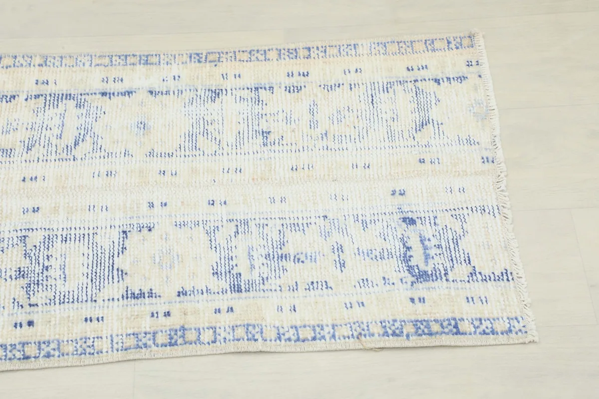 Close-up of one end of the runner, highlighting the distressed blue geometric motifs