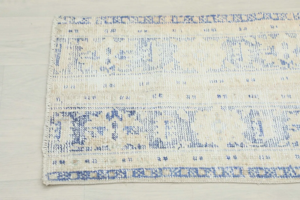 Close-up of the other end of the runner, showing the faded blue and ivory colors