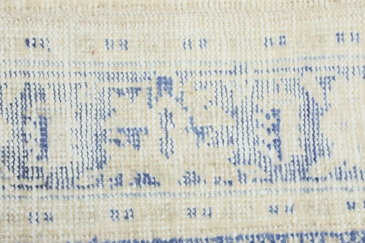 Detailed view of the low wool pile and hand-knotted construction with geometric patterns