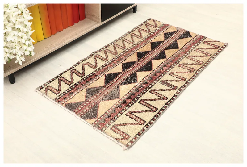 Full overhead view of the 2x4 vintage Anatolian rug with tan, rust, black, and gray geometric tribal patterns.