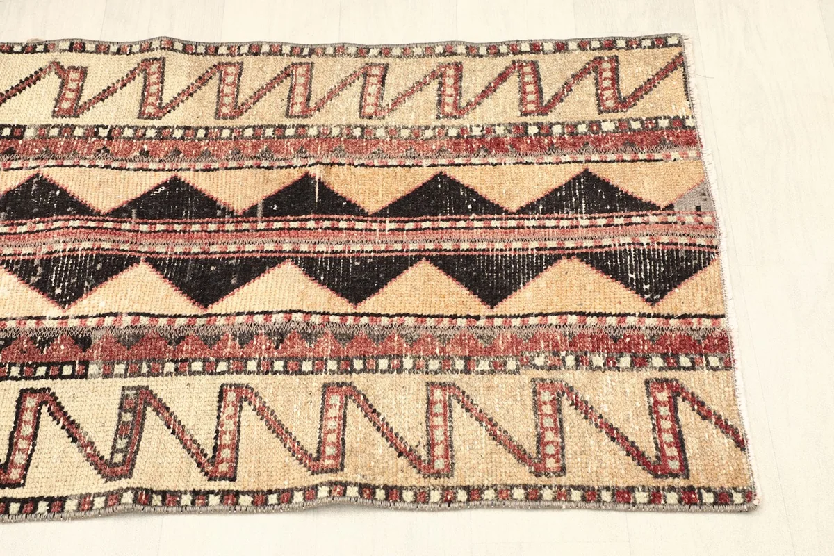 Another partial overhead view, showing the consistent tribal geometric patterns across the rug's width.