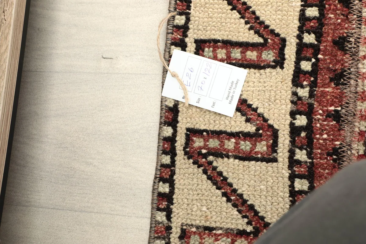 Close-up of the rug's corner with the product tag, showing the intricate details of the border.