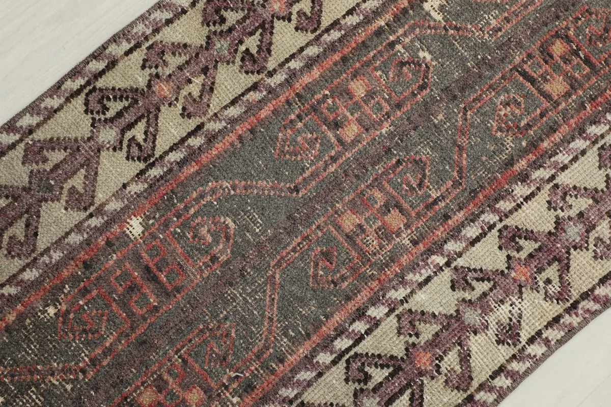 Diagonal close-up showing the texture and intricate geometric designs in the center and border.