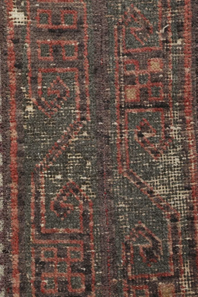 Extreme close-up of the low wool pile, revealing the hand-knotted texture and honest wear.