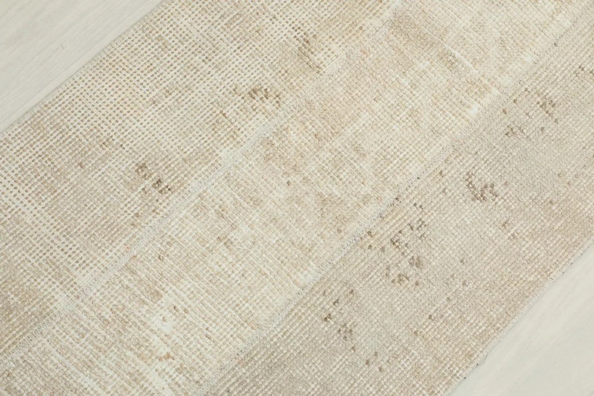 Diagonal close-up of the runner's surface, showing the low pile and hand-knotted wool texture.