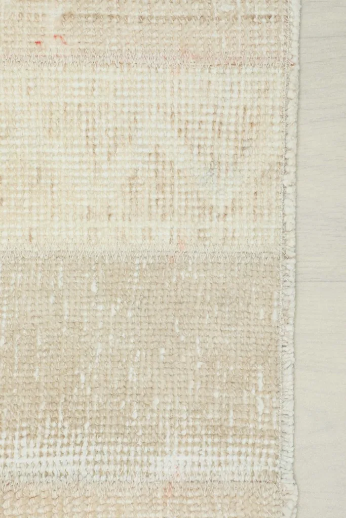 Close-up of the rug's low wool pile and hand-knotted texture