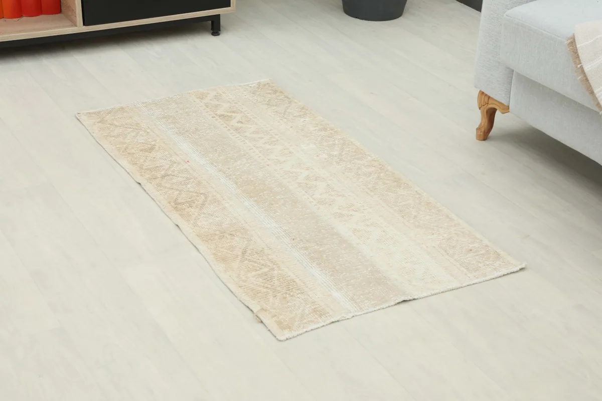 Overhead view of the beige and cream vintage rug showing its placement in a room