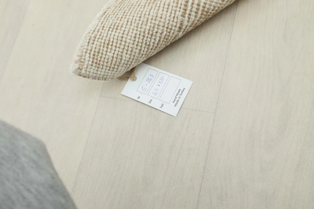Rug's product tag with size and origin information visible on the floor