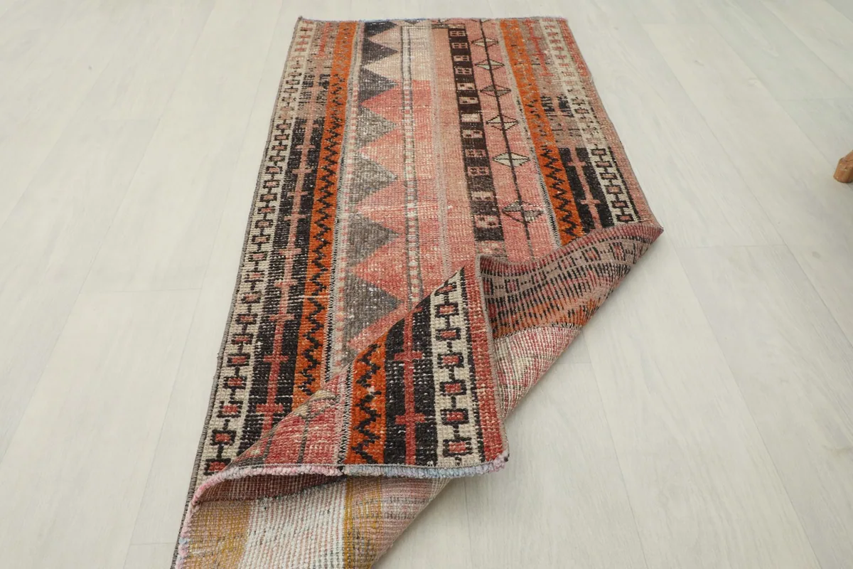 The rug folded to show its flexibility and thickness of the wool pile