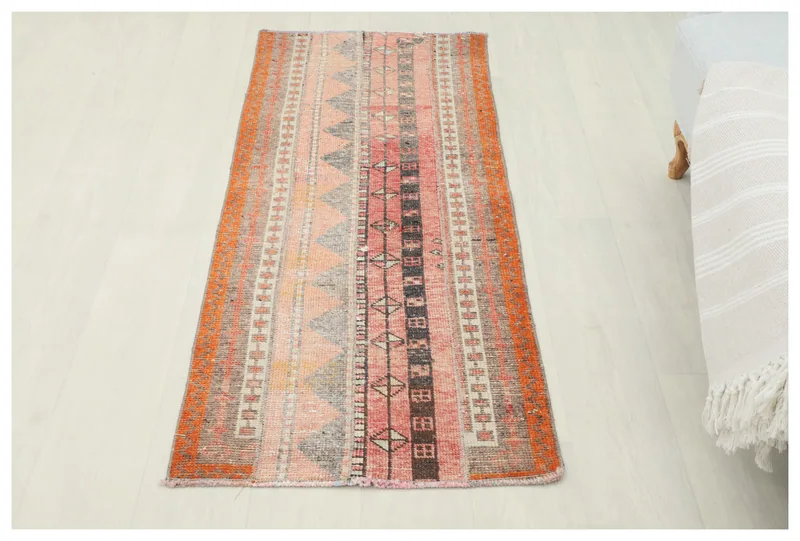 Full top view of the vintage Anatolian geometric runner rug on a white background.
