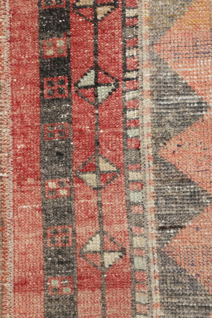 Macro view of the hand-knotted wool pile, showing texture and color depth.