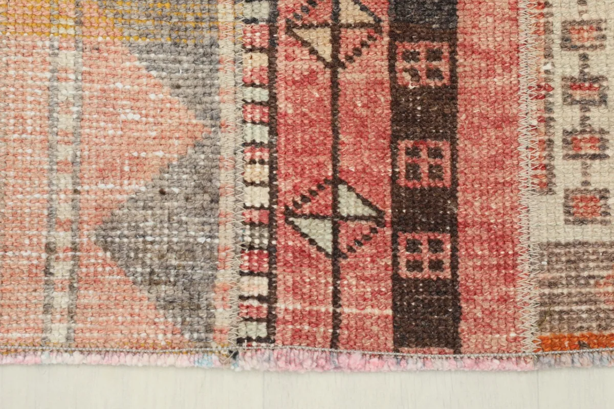 Detail of the rug's edge and short fringe, highlighting the construction.
