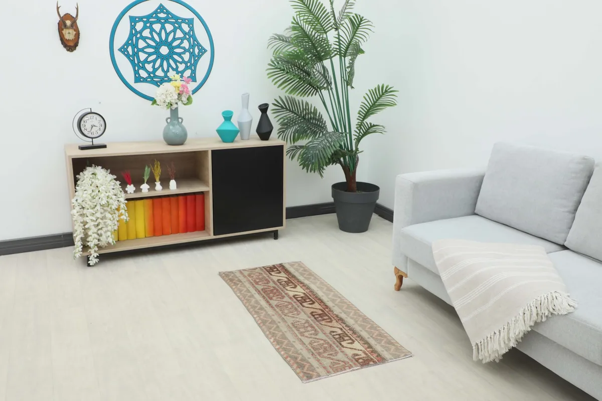 Vintage beige and gray tribal rug placed in a modern living room setting