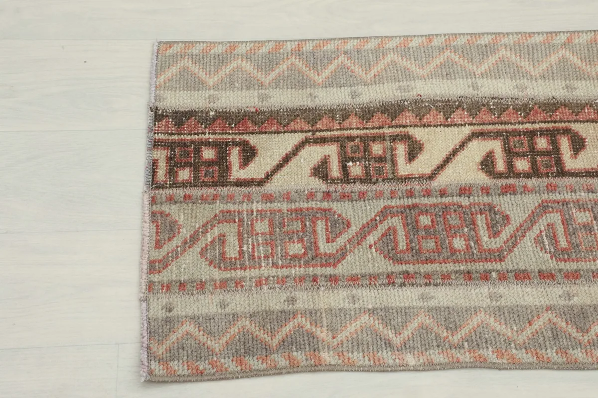 Detailed view of the rug's opposite end, showing the intricate tribal motifs