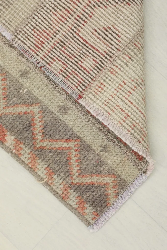 View of the rug's underside, showing the cotton foundation and knotting detail