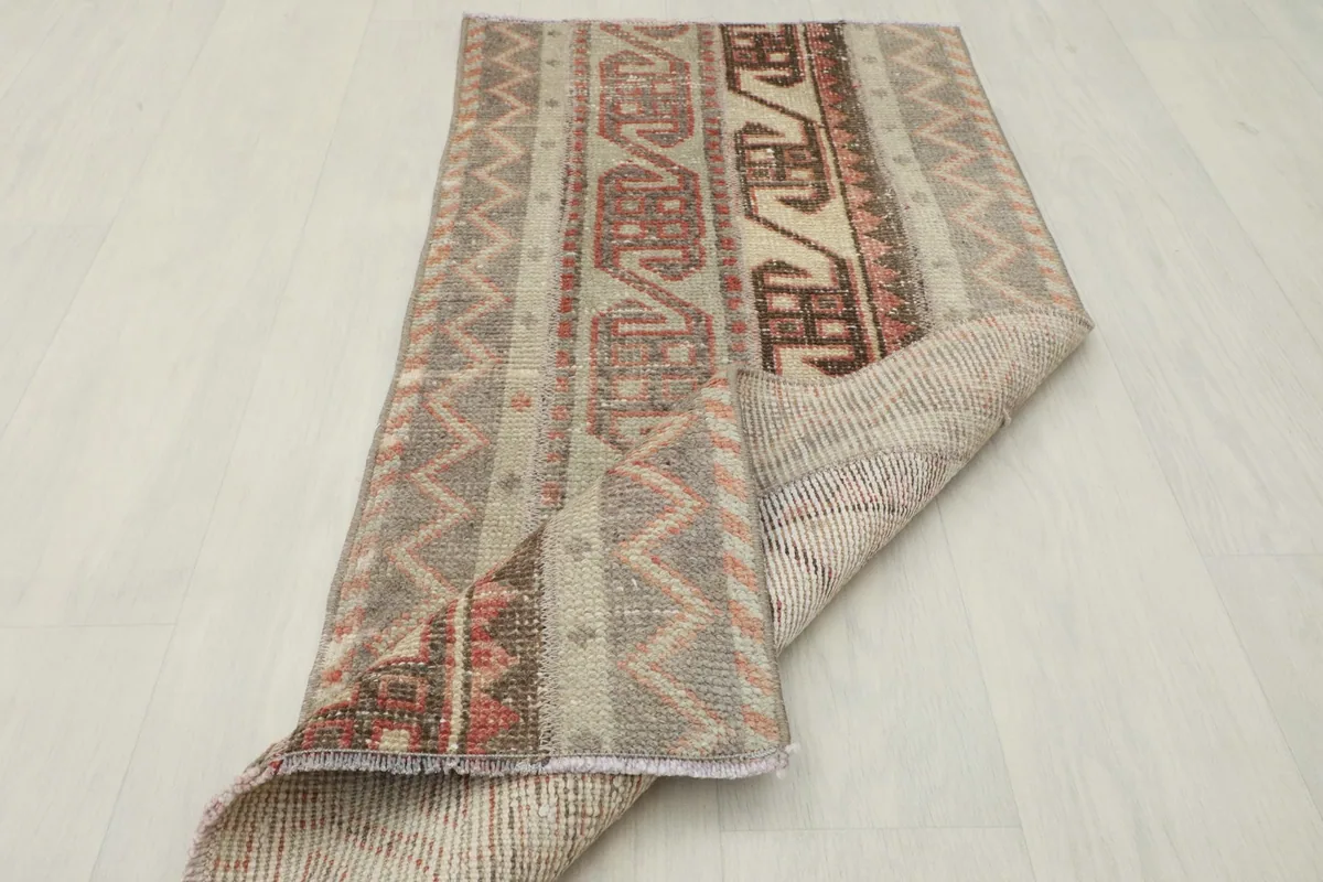 The rug folded to reveal both the pile side and the woven cotton foundation