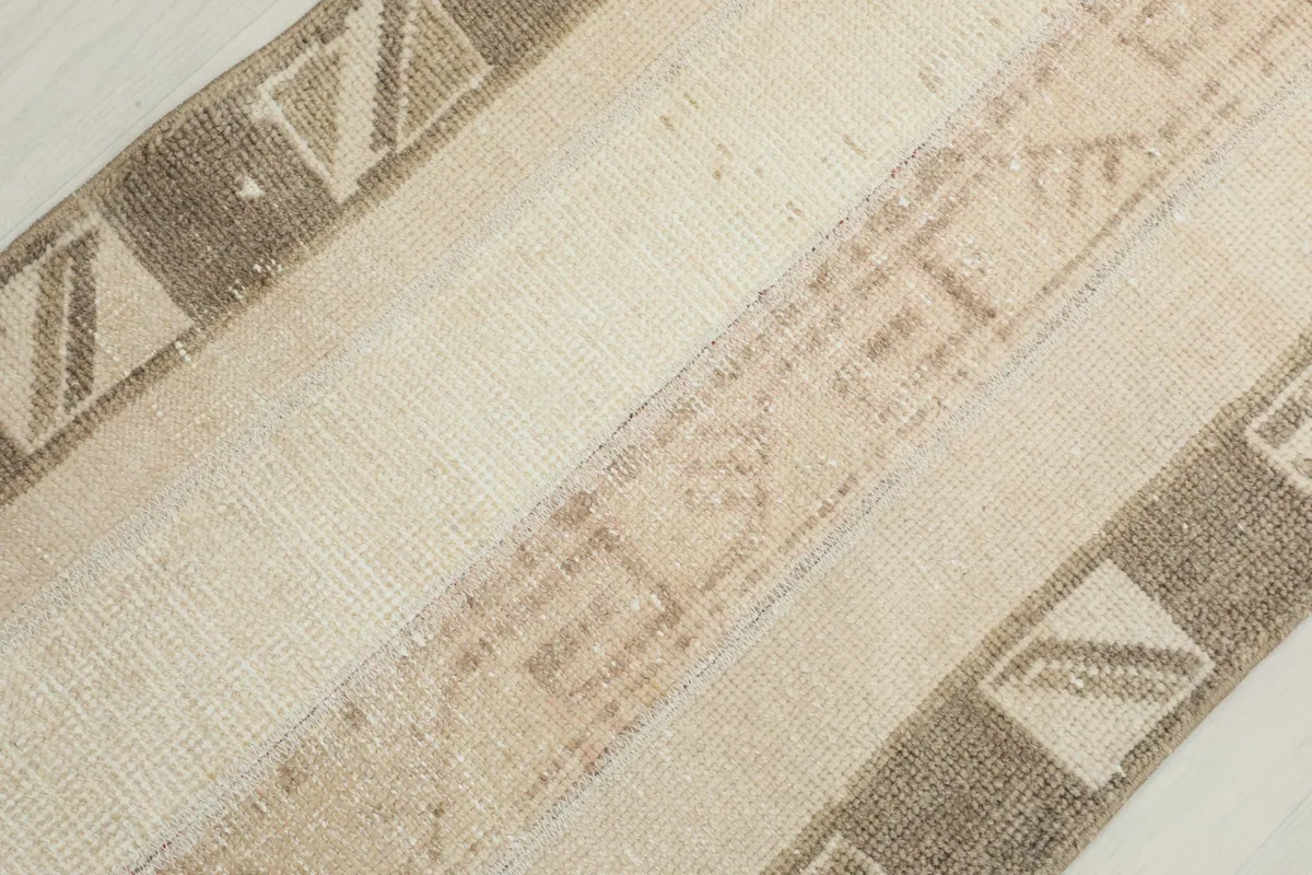 Diagonal close-up of the rug's surface, revealing the varied textures and pattern details.