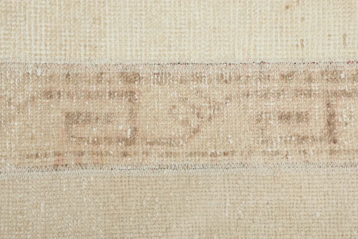 Macro shot of the central stripe, showing the fine hand-knotted texture and subtle tan motifs.