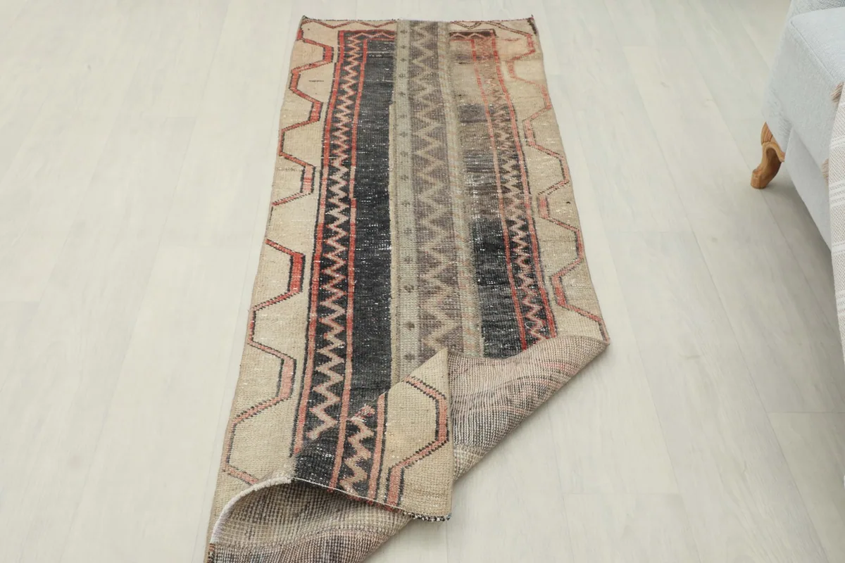 Rug partially folded, displaying both the top surface and the underside texture.