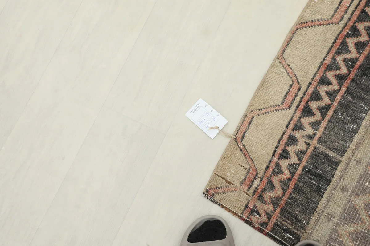 Overhead view showing a small tag on the rug, indicating its unique origin.
