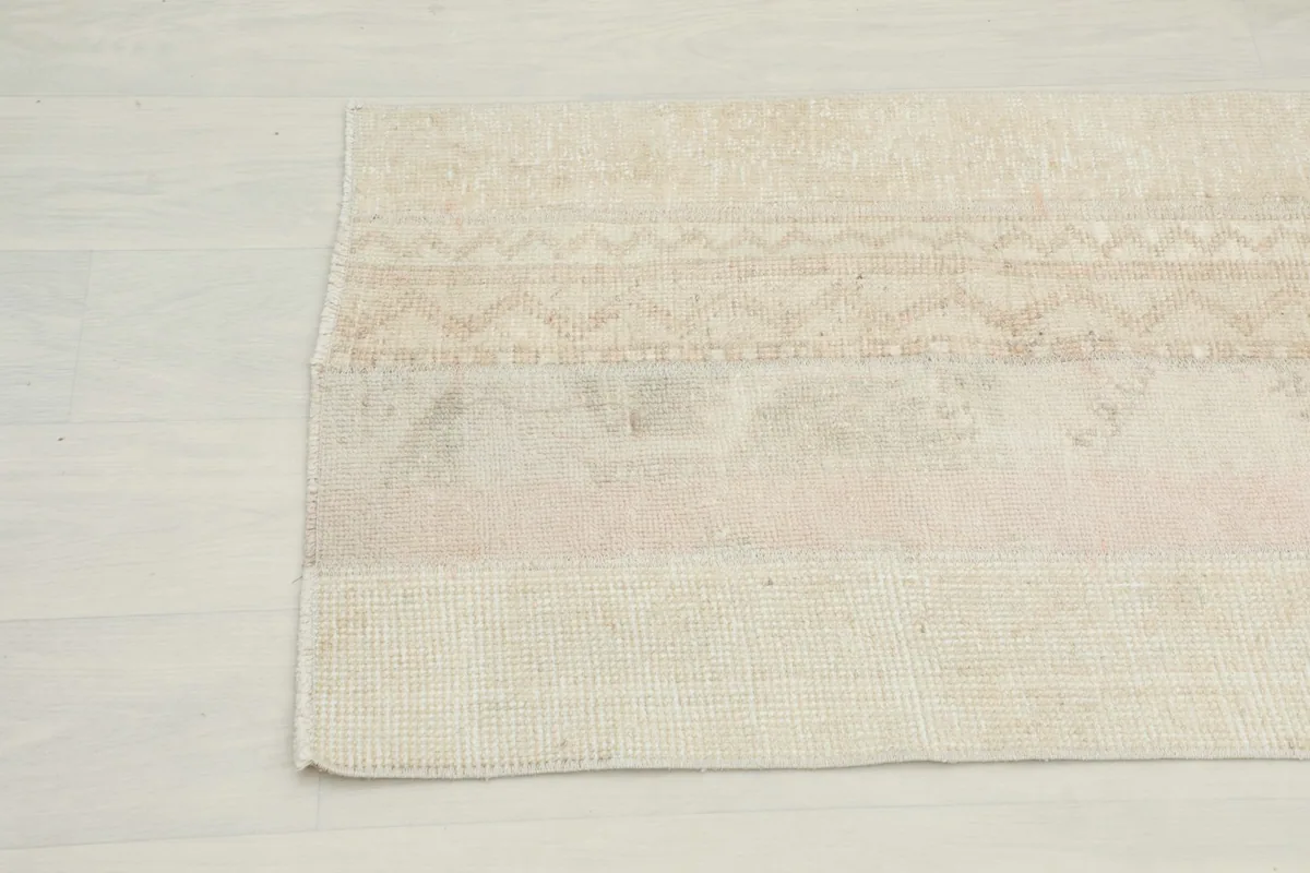 Detailed view of the rug's end, revealing the intricate patterns and the hand-knotted construction.