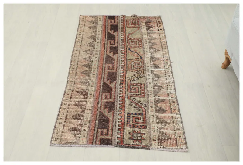 Full top view of the 2x4 beige and rust vintage Anatolian rug on a white background.