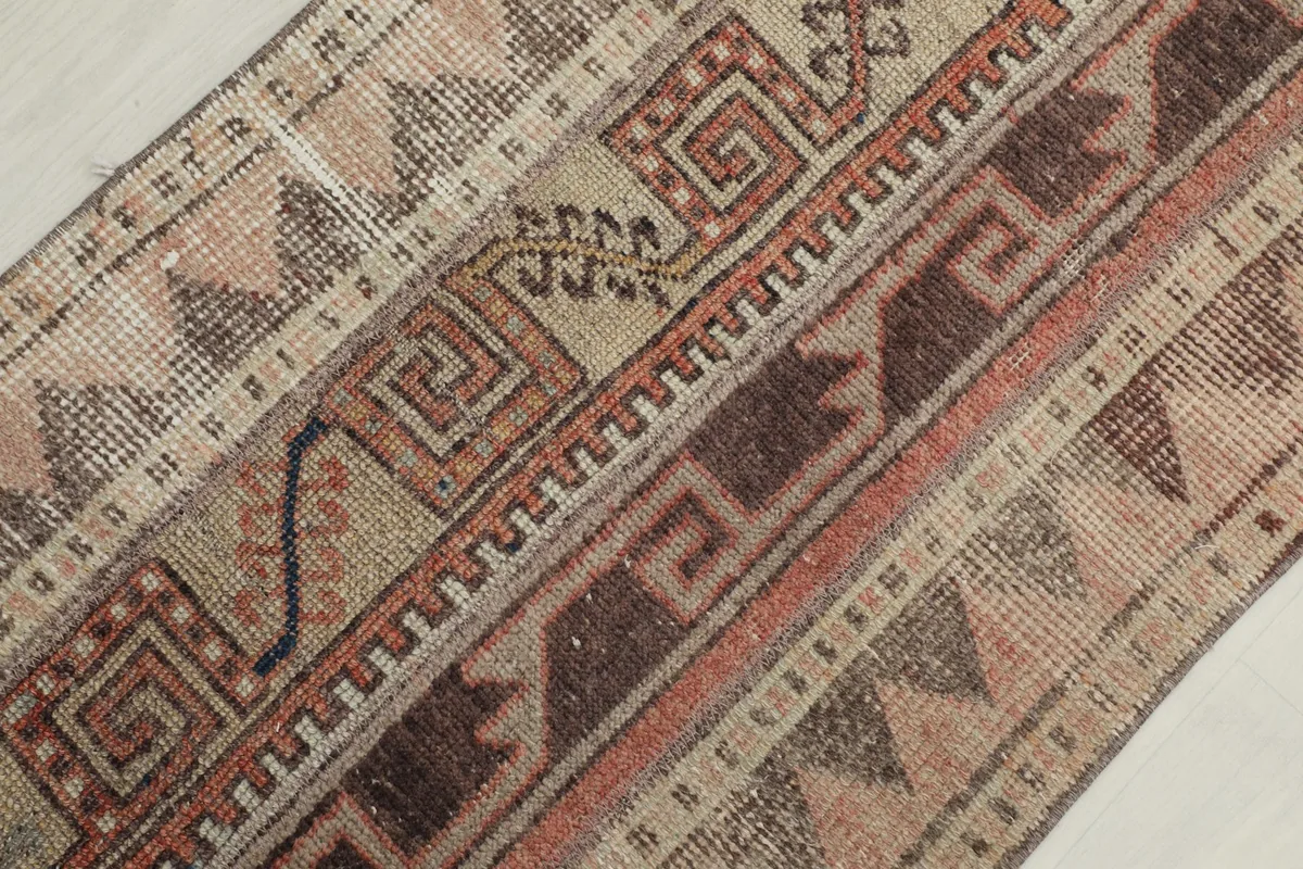 Overhead close-up of the rug's central design elements, including spiral and zigzag motifs.