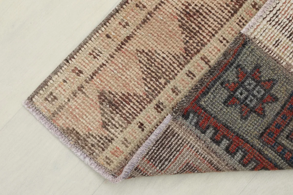 View of the back of the vintage hand-knotted rug, revealing the cotton foundation and knotting.