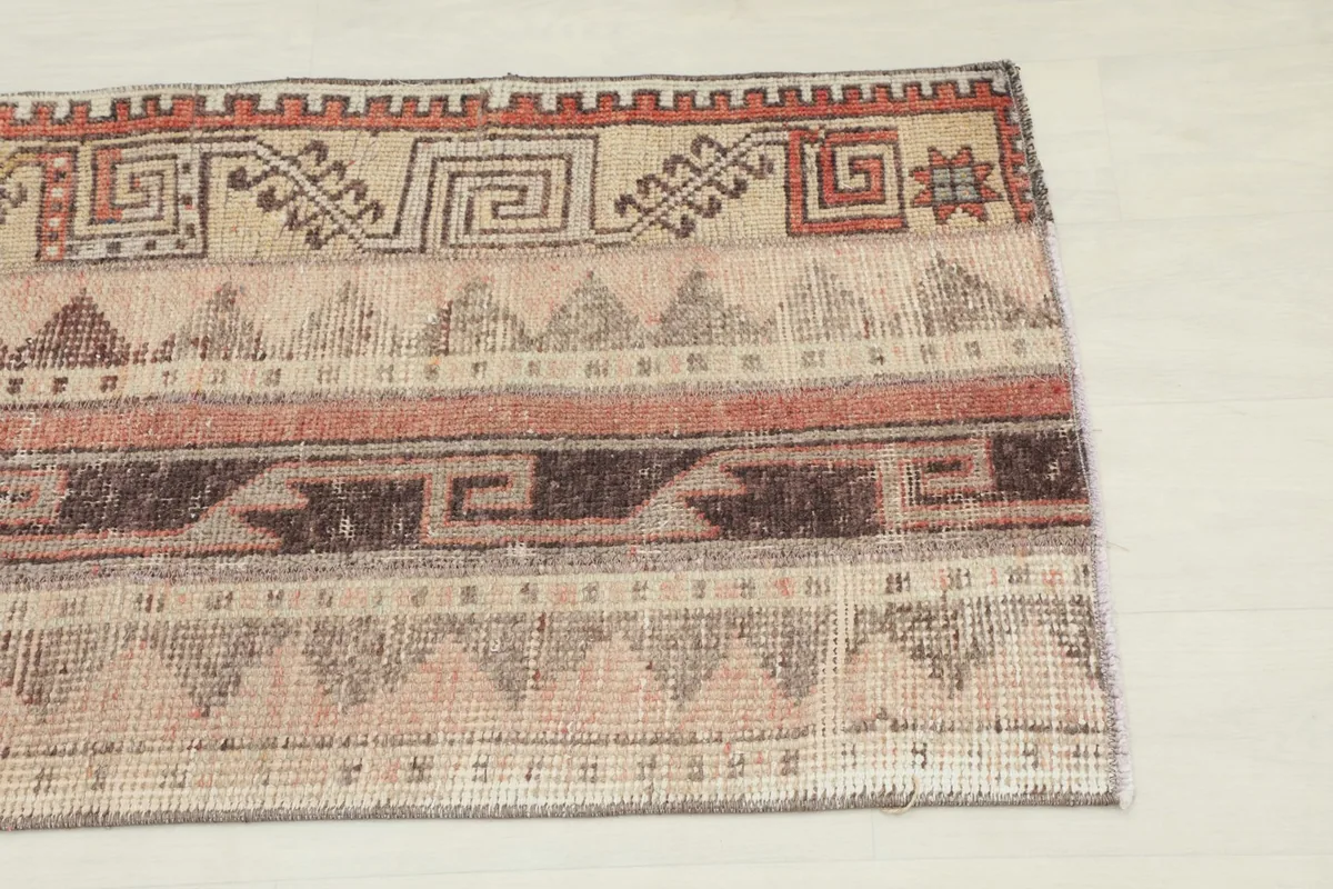 Close-up detail of the upper right section of the rug, showing distinct tribal and geometric motifs.