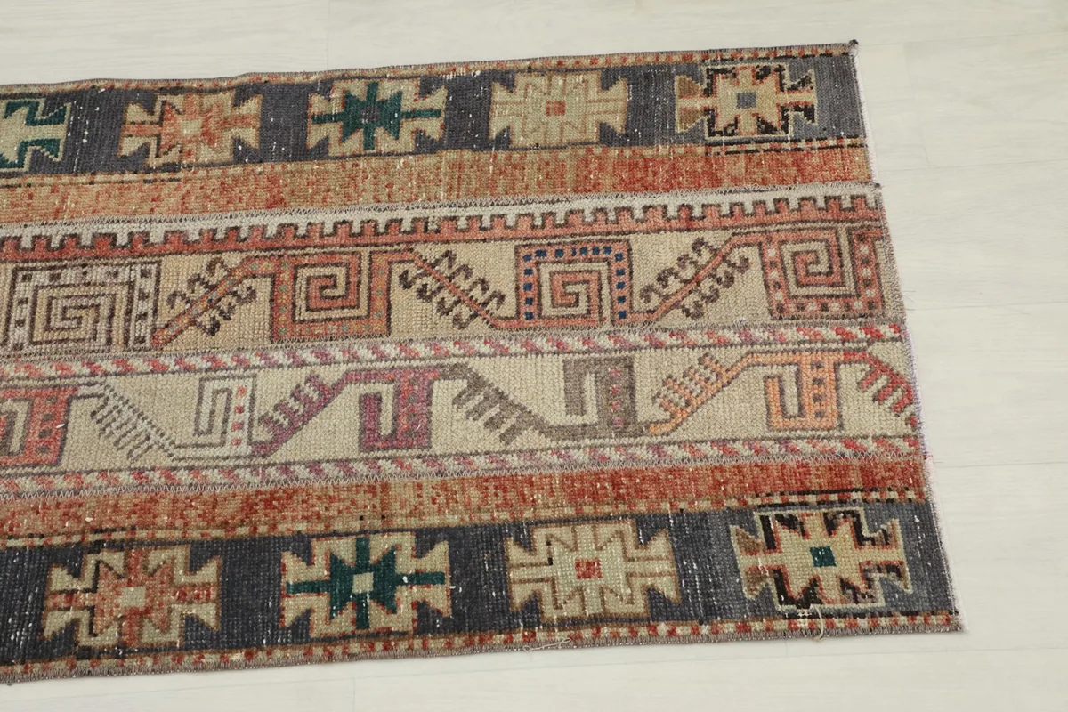 Close-up detail of the tribal geometric patterns and color variations on the rug surface