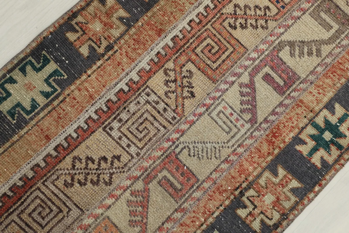 Diagonal close-up of the rug's patterns and texture, highlighting the hand-knotted wool