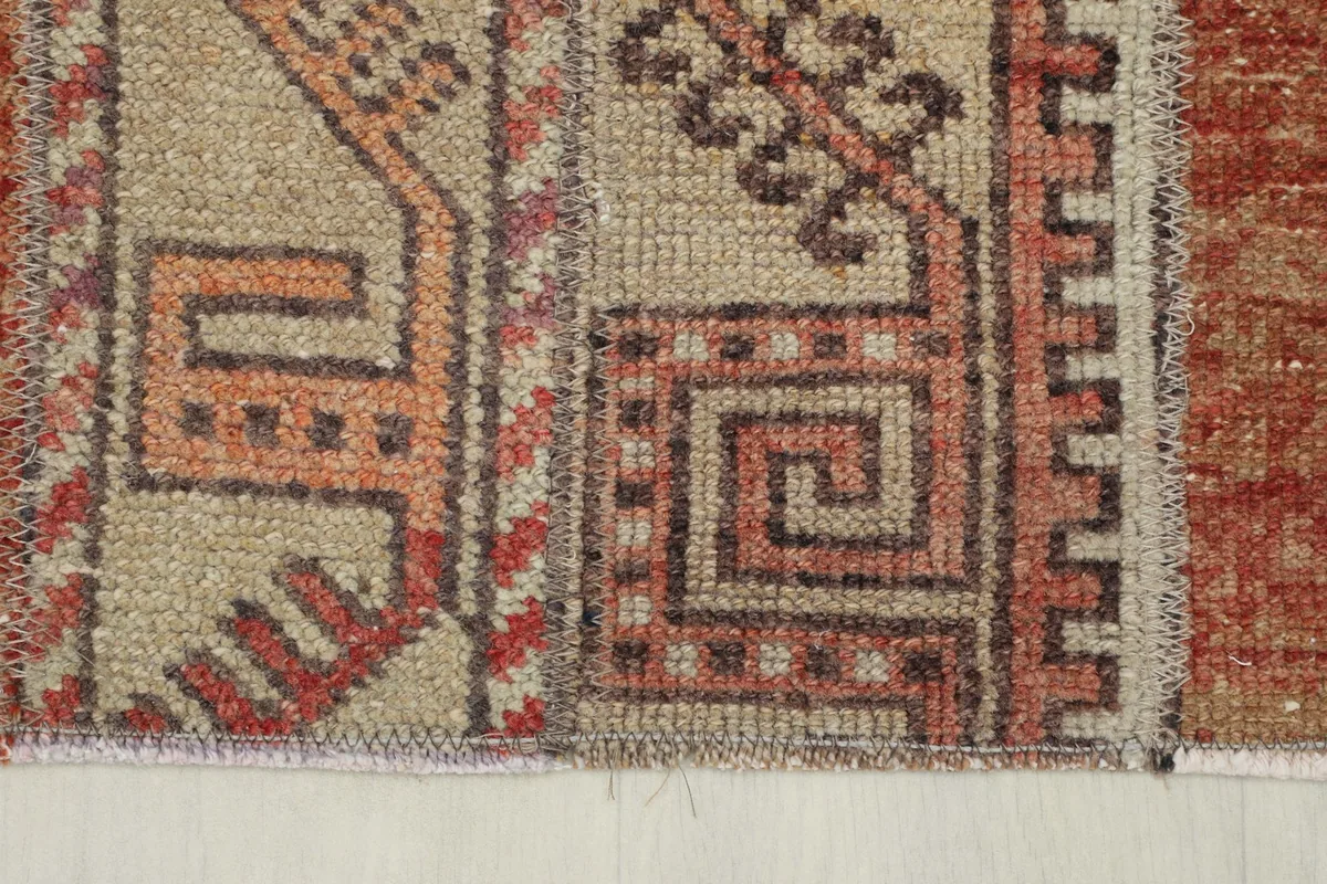 Close-up showing the low pile and texture of the hand-knotted wool on cotton foundation