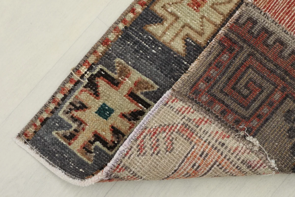 View of the rug's underside, revealing the cotton foundation and hand-knotted construction