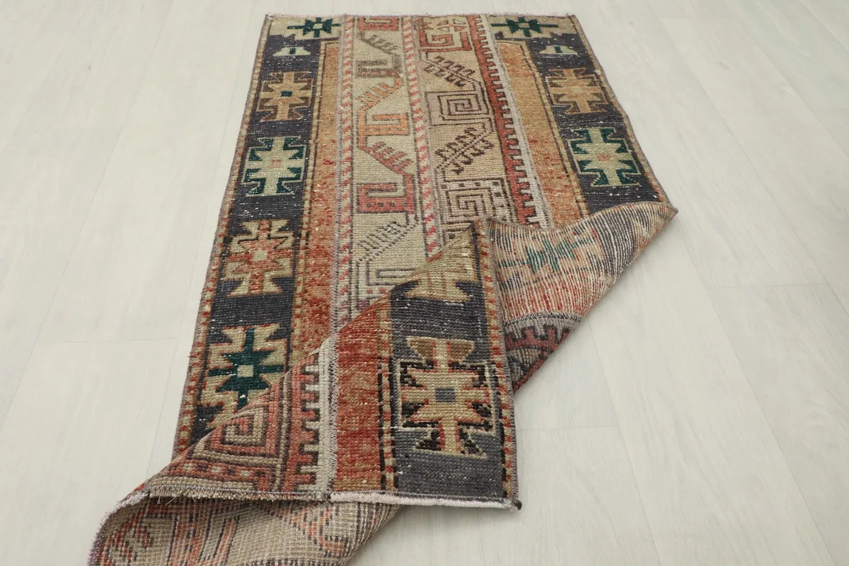The rug partially folded, showing its flexibility and the reverse side of the weave