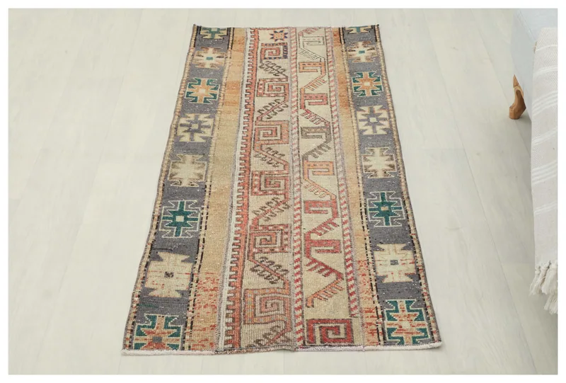 Full top view of the beige, rust, and gray geometric vintage Anatolian rug