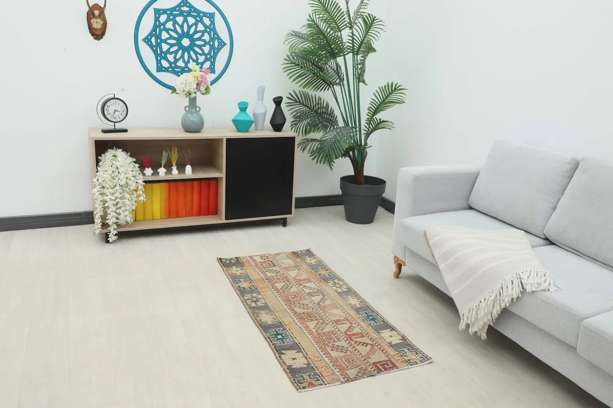 Vintage Anatolian rug placed in a modern living space with a couch and console table