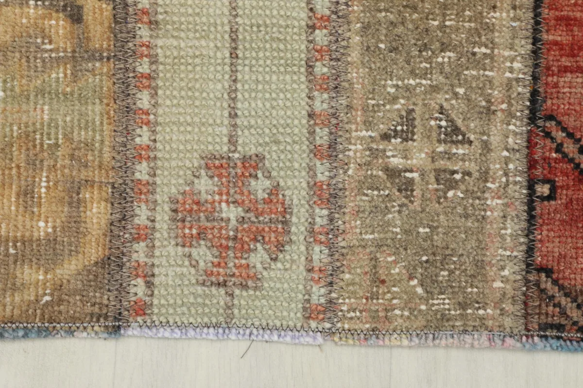 Close-up of the rug's low pile and fringed edge, showing the hand-knotted texture