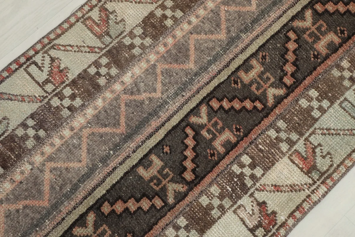 Diagonal close-up of the runner's texture and intricate geometric and tribal designs.