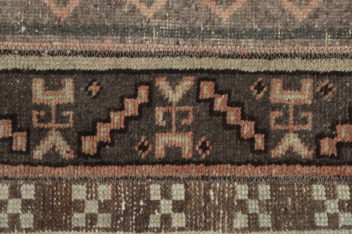 Extreme close-up of a dark brown stripe with distinct geometric and tribal symbols.