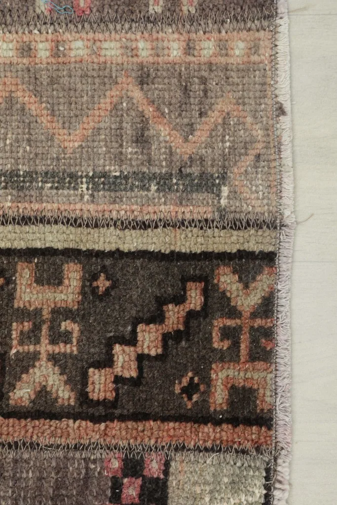 Close-up showing the edge of the runner and the detail of the hand-knotted pile and foundation.