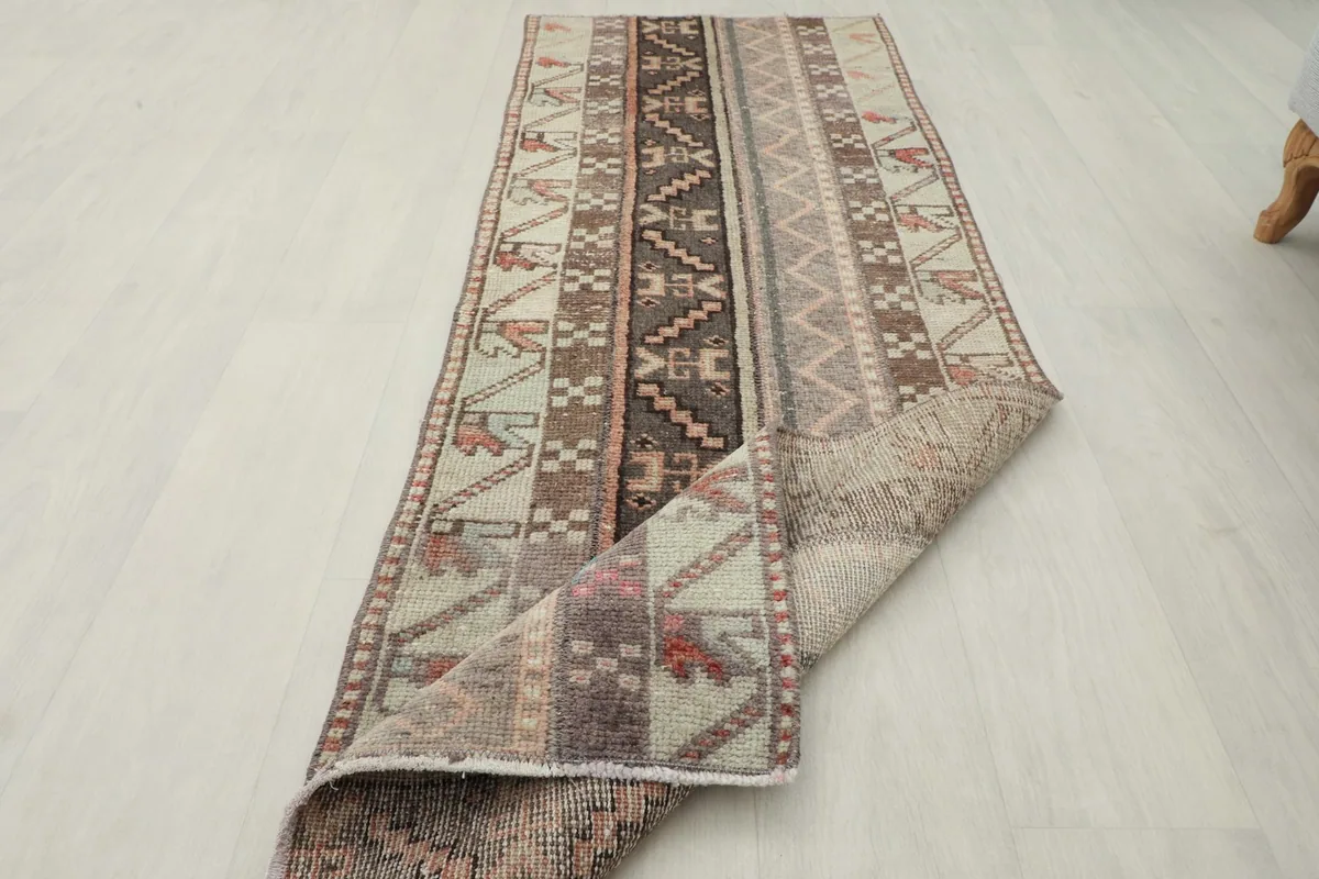 The runner partially folded, showcasing the thickness of the wool pile and overall condition.