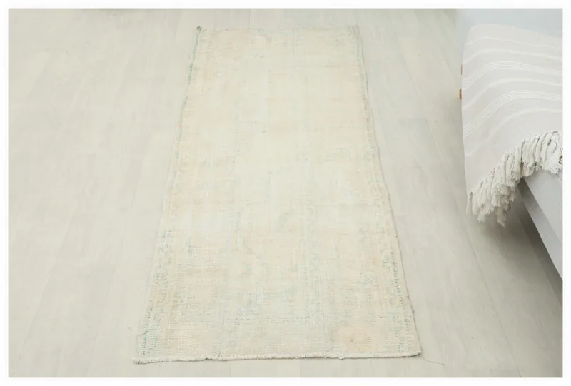 Full top view of the vintage ivory and beige Anatolian runner rug on a white background.